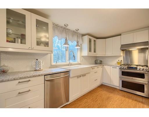 247 Sandy Pond Road Concord, MA 01773 - Photo 2 of 20 a kitchen with granite countertop a sink stainless steel appliances and cabinets