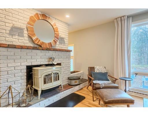 247 Sandy Pond Road Concord, MA 01773 - Photo 7 of 20 a living room with furniture and a fireplace