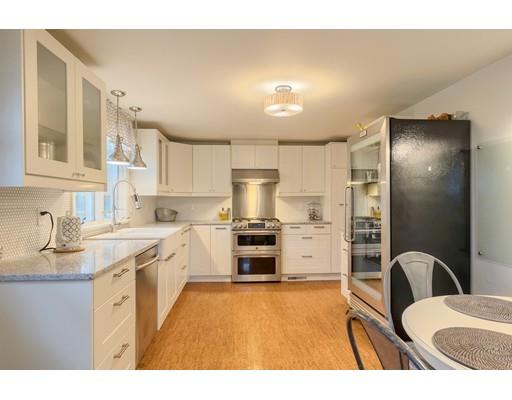 247 Sandy Pond Road Concord, MA 01773 - Photo 10 of 20 a kitchen with stainless steel appliances a stove a sink dishwasher a refrigerator with a dining table and chairs