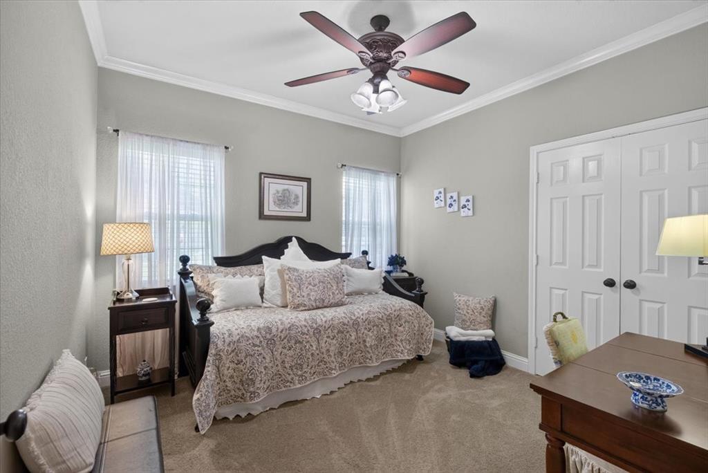 111 Trailwood Road Enchanted Oaks, TX 75156 - Photo 20 of 33 a bedroom with a bed a couch and a dresser with wooden floor