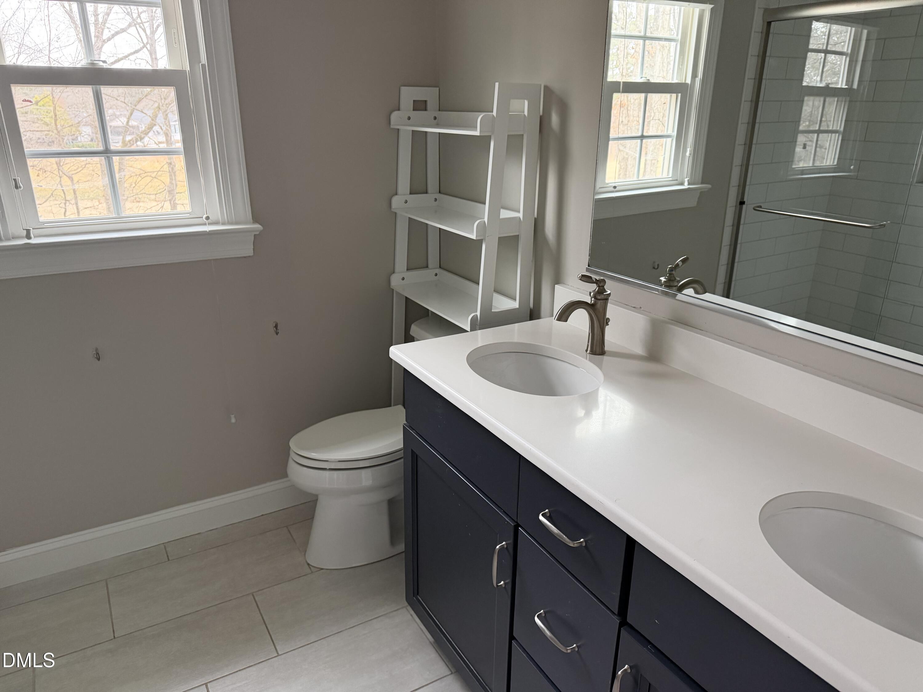 7824 Hardwick Drive Raleigh, NC 27615 - Photo 13 of 15 a bathroom with a sink toilet and window