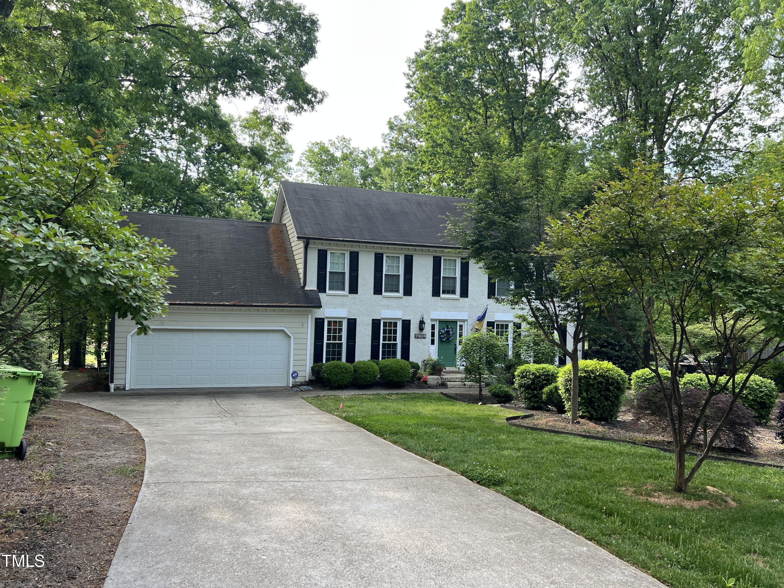 7824 Hardwick Drive Raleigh, NC 27615 - Photo 2 of 15 a front view of a house with a yard and trees