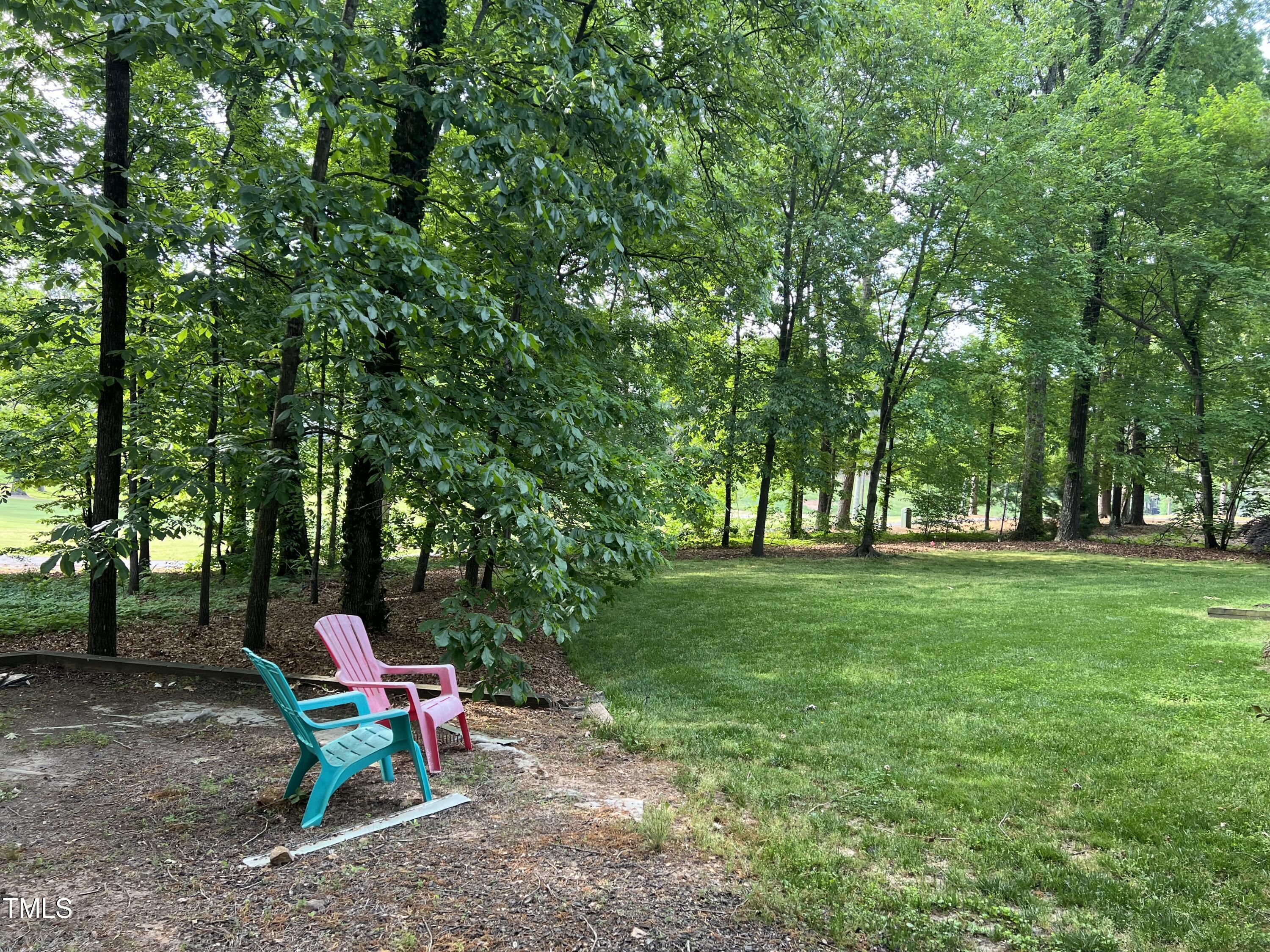 7824 Hardwick Drive Raleigh, NC 27615 - Photo 3 of 15 a view of a wooden bench sitting in the middle of a park