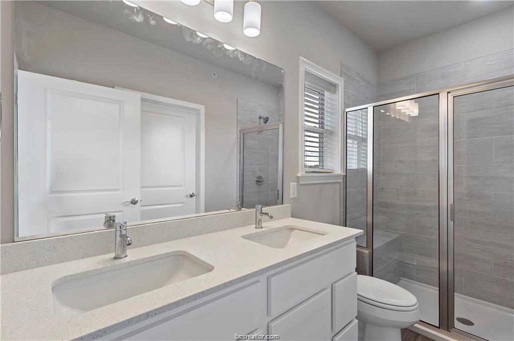 1326 Prairie Drive, Unit 513 Bryan, TX 77803 - Photo 13 of 18 a bathroom with a sink toilet and shower