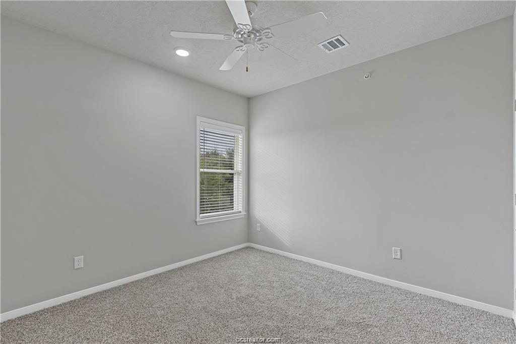 1326 Prairie Drive, Unit 513 Bryan, TX 77803 - Photo 14 of 18 an empty room with a window and a fan