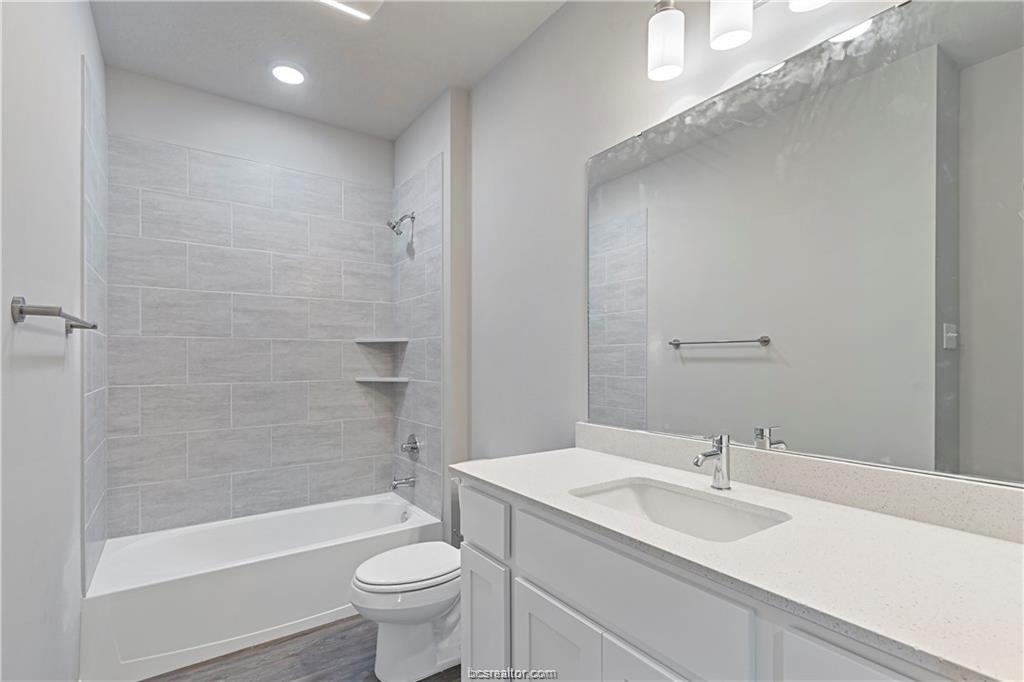 1326 Prairie Drive, Unit 513 Bryan, TX 77803 - Photo 15 of 18 a bathroom with a sink a toilet and shower
