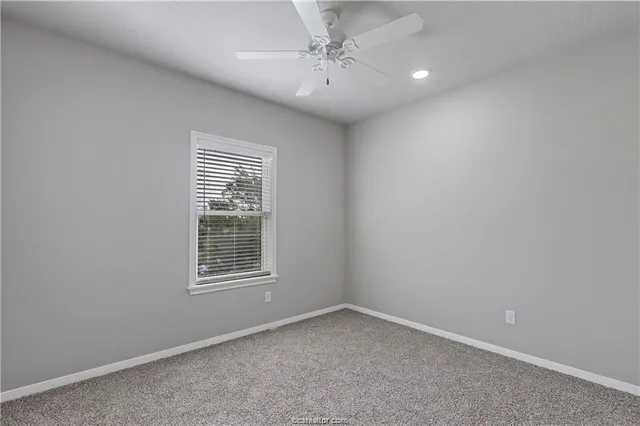a bathroom with a granite countertop toilet a sink and a bathtub