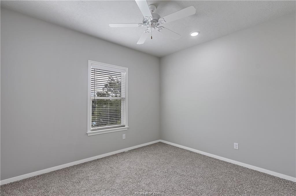 1326 Prairie Drive, Unit 513 Bryan, TX 77803 - Photo 16 of 18 an empty room with a window and ceiling fan