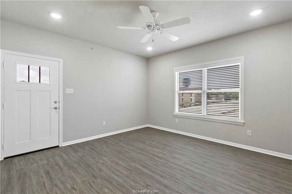 1326 Prairie Drive, Unit 513 Bryan, TX 77803 - Photo 3 of 18 wooden floor in an empty room with a window