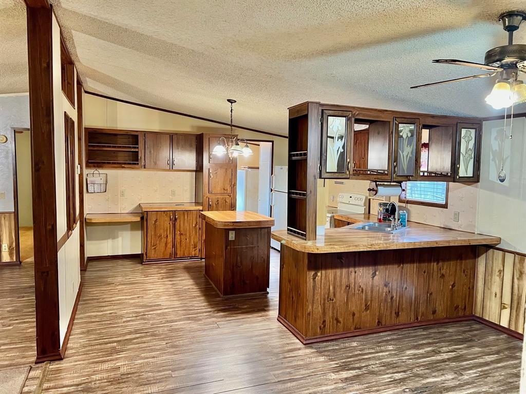 620 Cr 109 Road Riesel, TX 76682 - Photo 4 of 26 a kitchen with stainless steel appliances granite countertop a sink and wooden cabinets