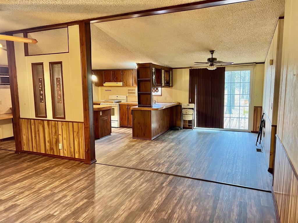 620 Cr 109 Road Riesel, TX 76682 - Photo 6 of 27 a view of a kitchen with a refrigerator and wooden floor