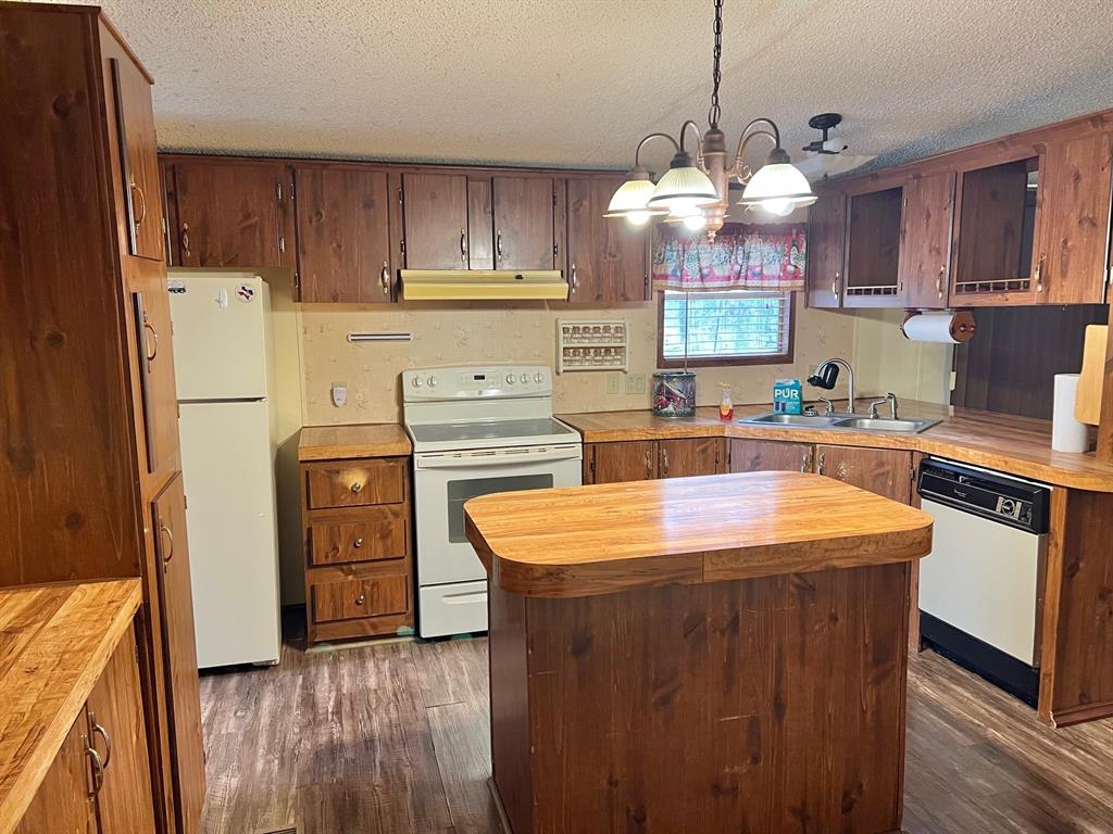 620 Cr 109 Road Riesel, TX 76682 - Photo 6 of 26 a kitchen with stainless steel appliances granite countertop a sink stove and refrigerator