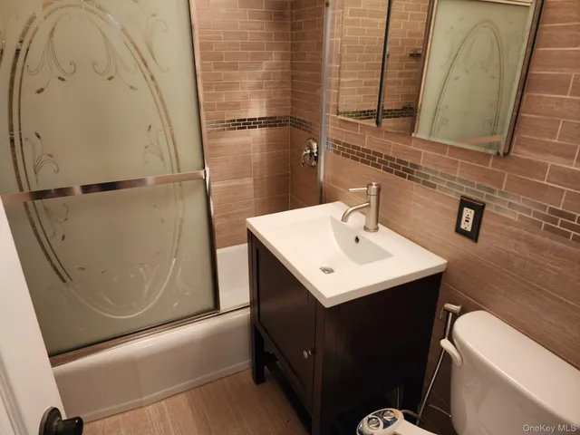 a view of balcony with a couple of cars parked in the parking