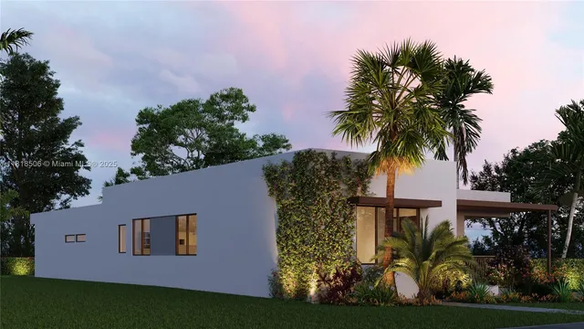 a view of a yard with plants and palm trees