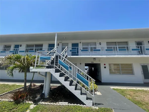 a front view of house with deck and outdoor seating