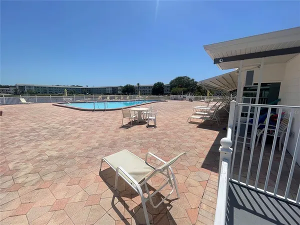 a living room with lots of furniture and a wooden floor