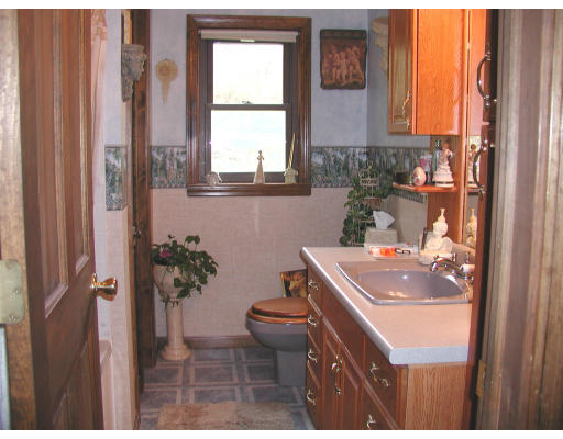 50-52 Holcomb Road Chester, MA 01011 - Photo 7 of 11 a bathroom with a sink toilet and window