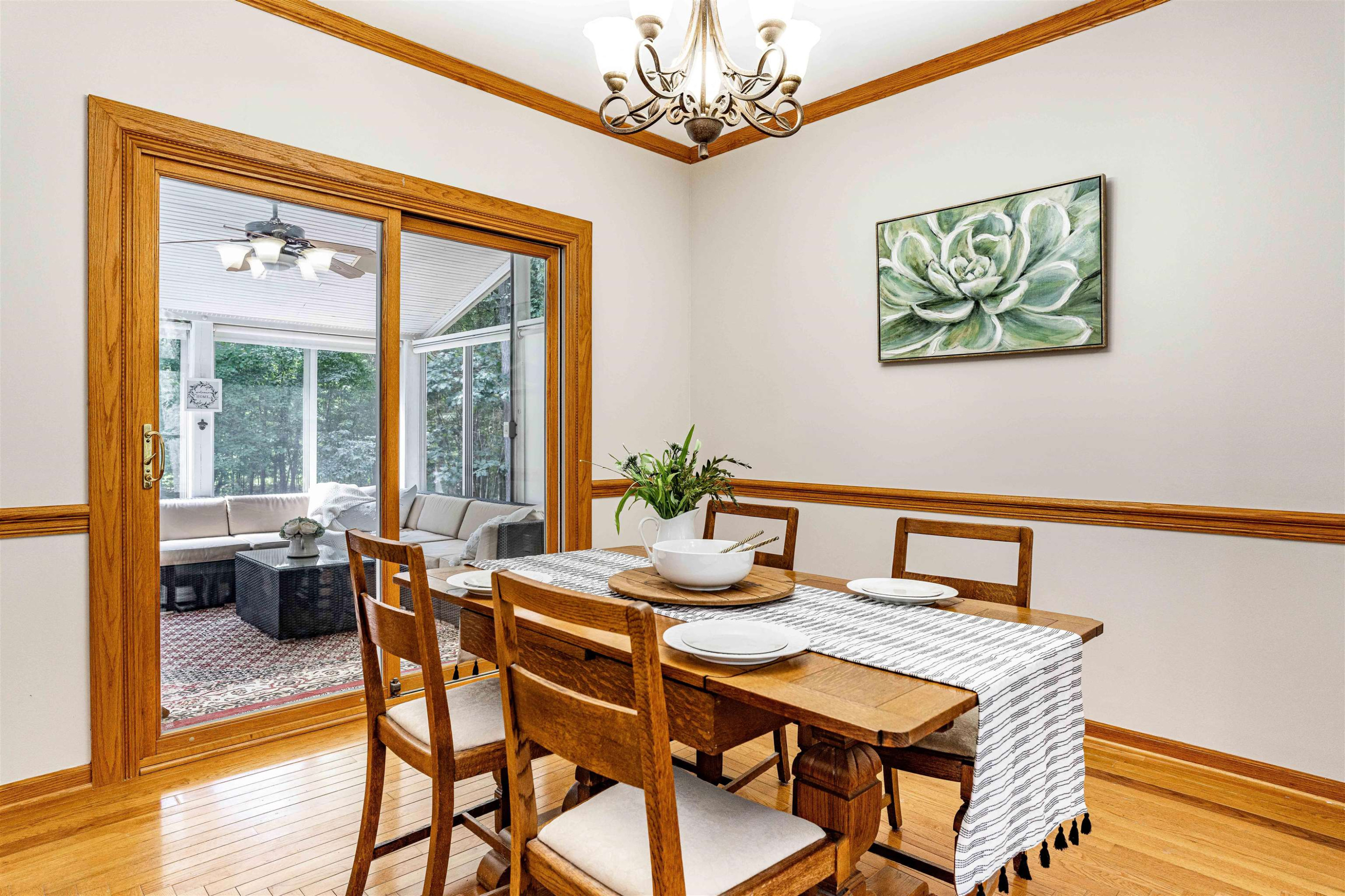 407 Catlin Road Cary, NC 27519 - Photo 17 of 42 a dining room with furniture a large window and wooden floor