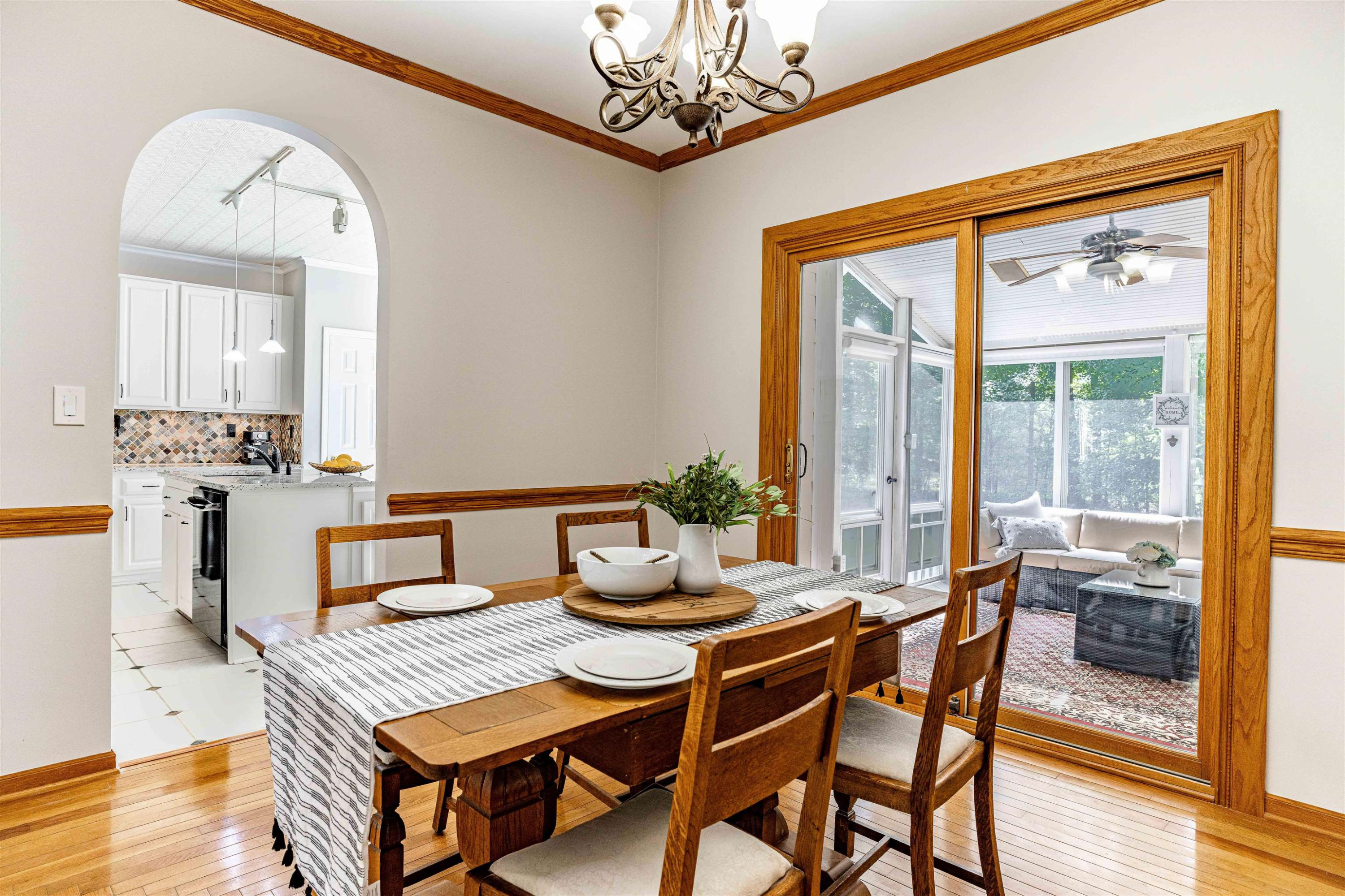 407 Catlin Road Cary, NC 27519 - Photo 4 of 42 a dining room with furniture a chandelier and wooden floor