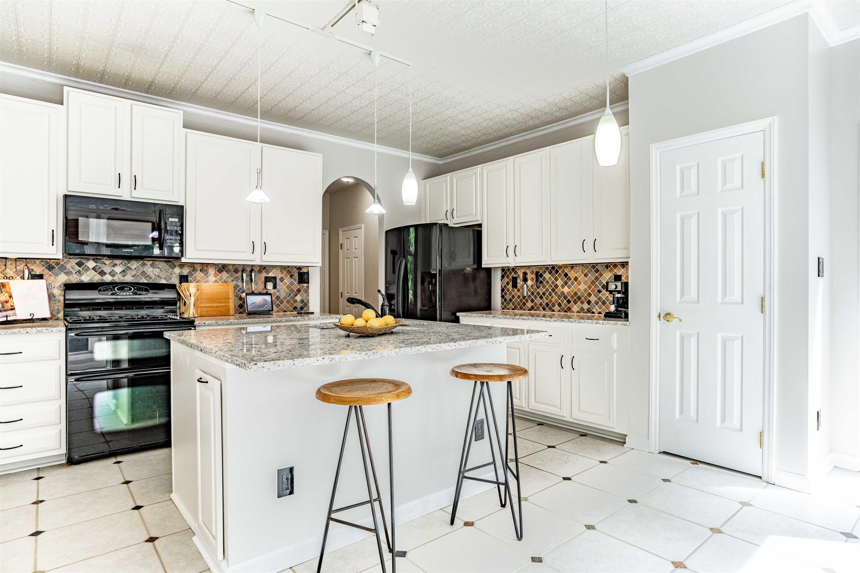 407 Catlin Road Cary, NC 27519 - Photo 5 of 42 a kitchen with stainless steel appliances kitchen island granite countertop a table chairs and a refrigerator