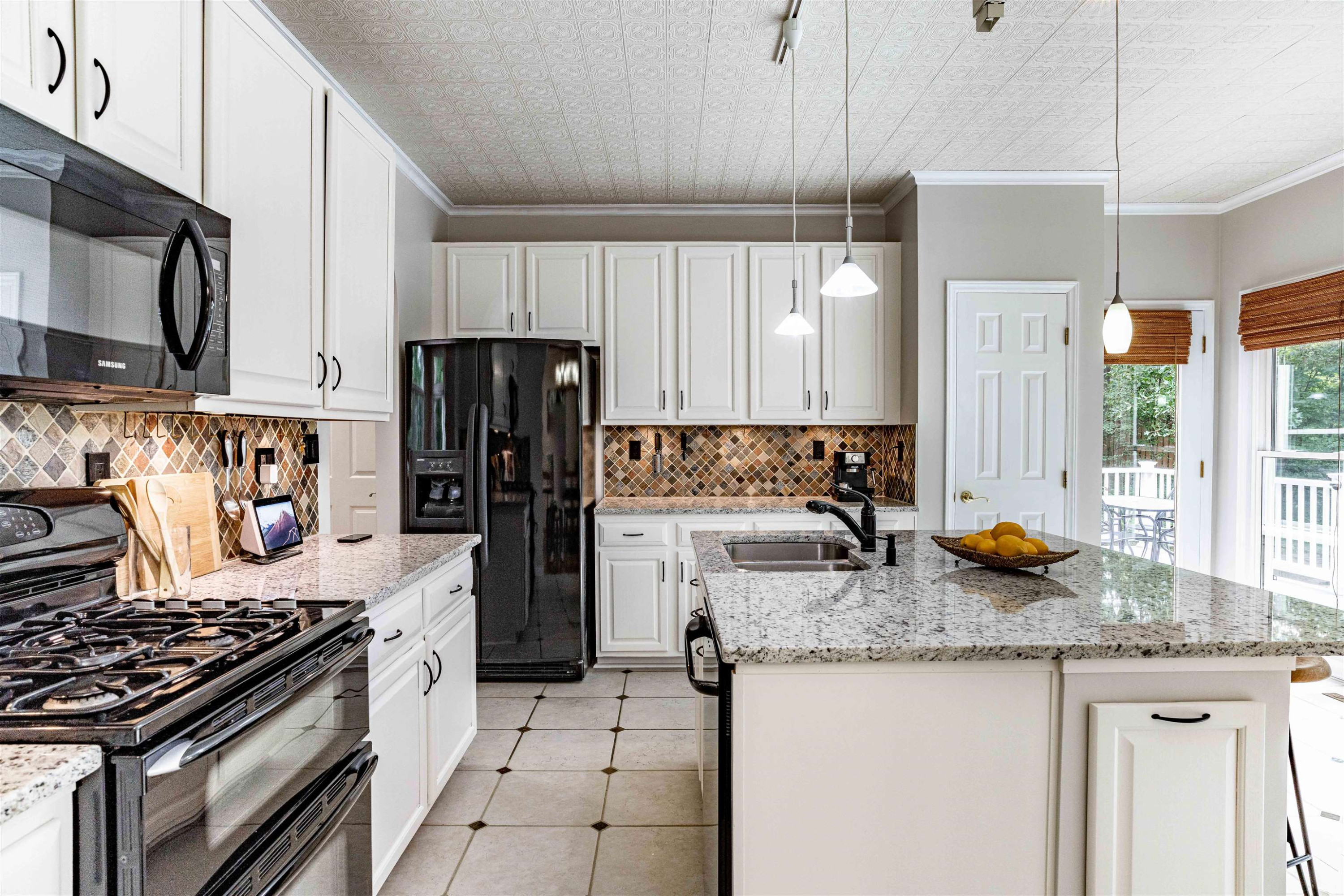 407 Catlin Road Cary, NC 27519 - Photo 9 of 42 a kitchen with granite countertop kitchen island stainless steel appliances a stove a refrigerator a sink a counter space and cabinets
