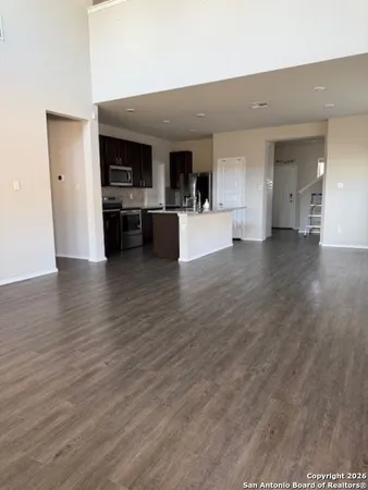 a view of living room with furniture and kitchen view