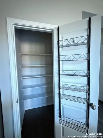 a view of walk in closet with empty racks
