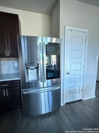 a kitchen with kitchen island a counter top space cabinets and stainless steel appliances