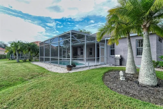 a view of a hallway with wooden floor and a chandelier fan