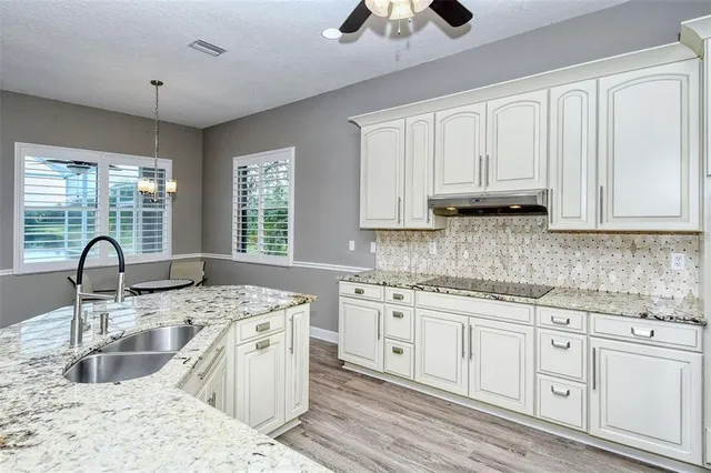 a dining room with a wooden table and chairs