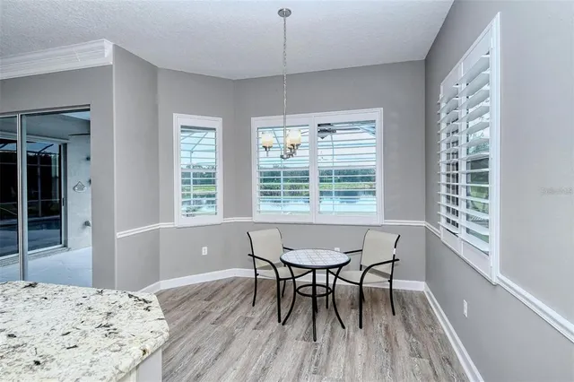 a kitchen with a stove and a wooden floor