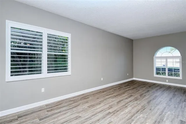wooden floor in an empty room with a window