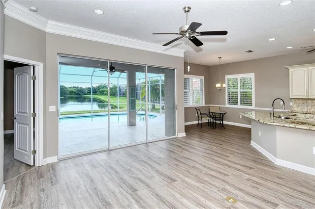 a view of livingroom with wooden floor and ceiling fan