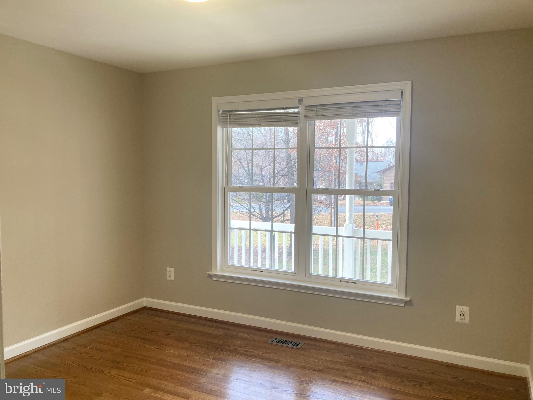 3002 Lakeview Parkway Locust Grove, VA 22508 - Photo 11 of 18 a view of an empty room with wooden floor and a window
