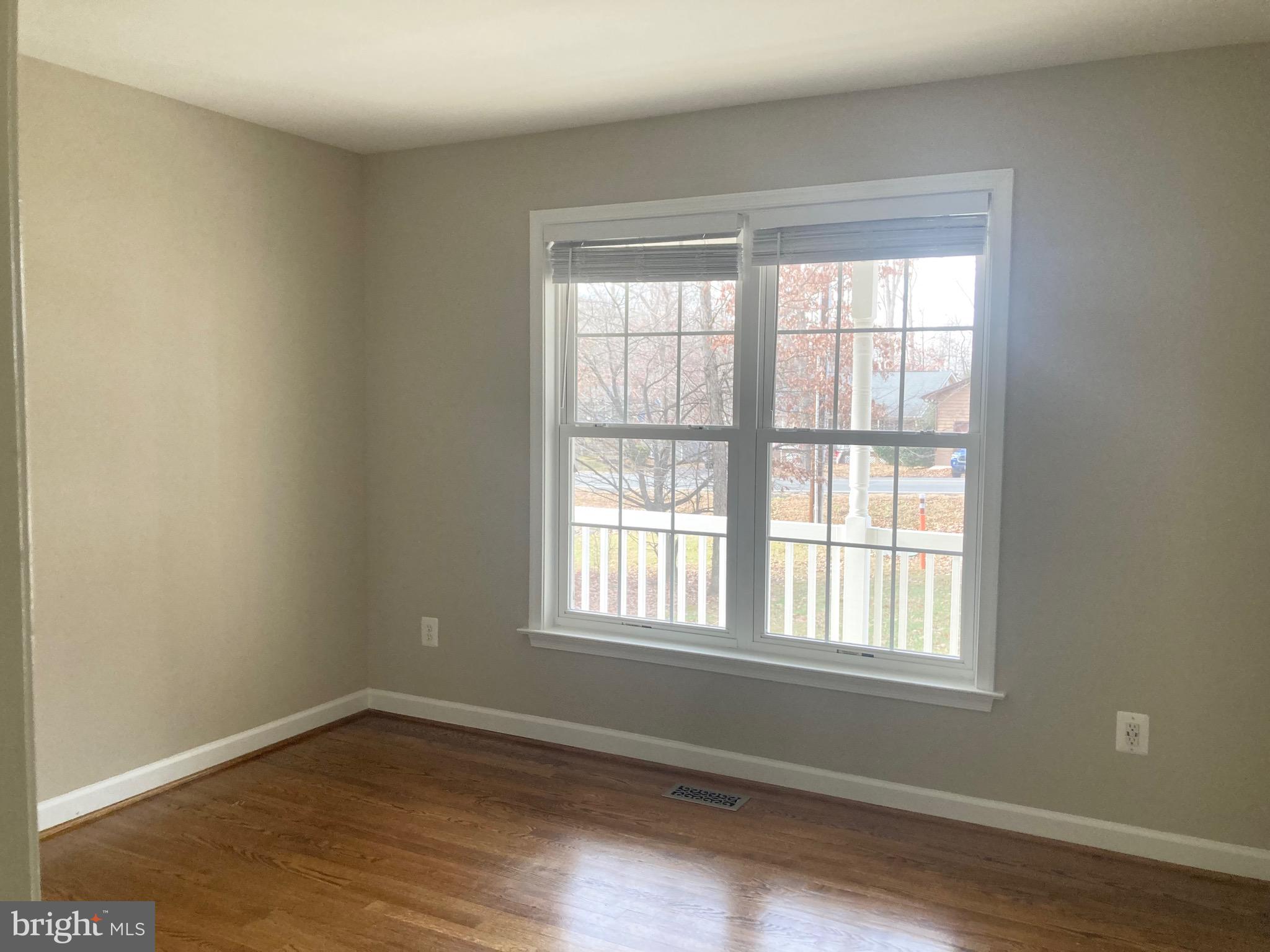 3002 Lakeview Parkway Locust Grove, VA 22508 - Photo 12 of 18 a view of an empty room with wooden floor and a window