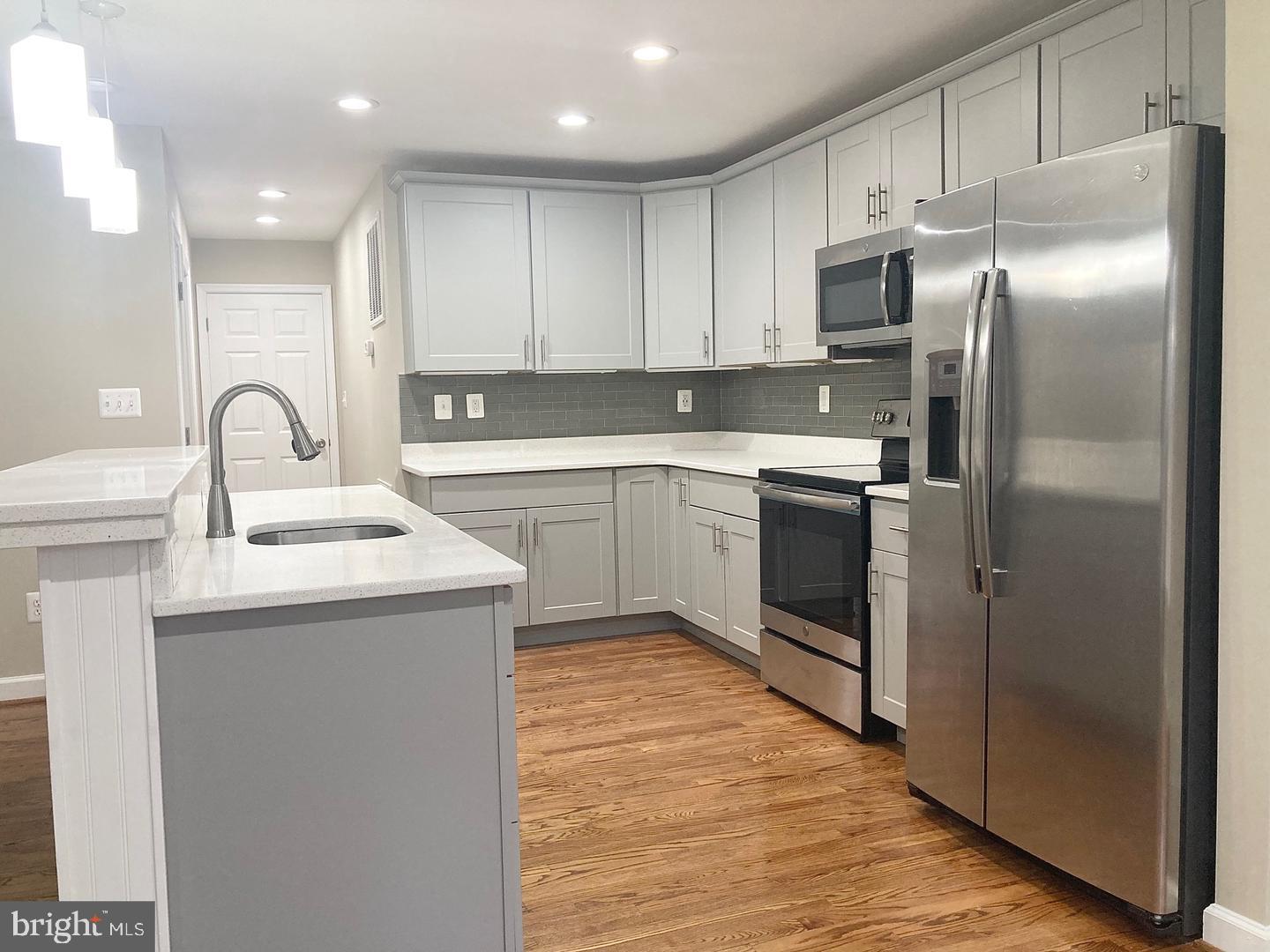 3002 Lakeview Parkway Locust Grove, VA 22508 - Photo 5 of 18 a kitchen with a sink stainless steel appliances and white cabinets