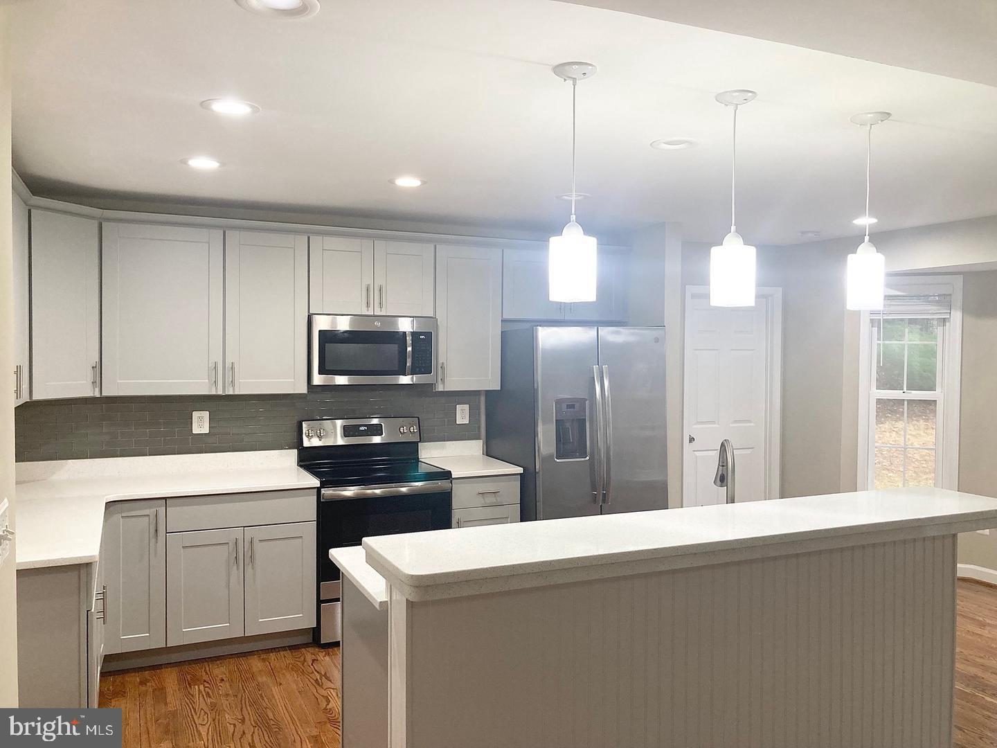 3002 Lakeview Parkway Locust Grove, VA 22508 - Photo 6 of 18 a kitchen that has a sink stainless steel appliances a refrigerator and a stove top oven