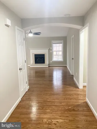 a view of an empty room with a window and fireplace