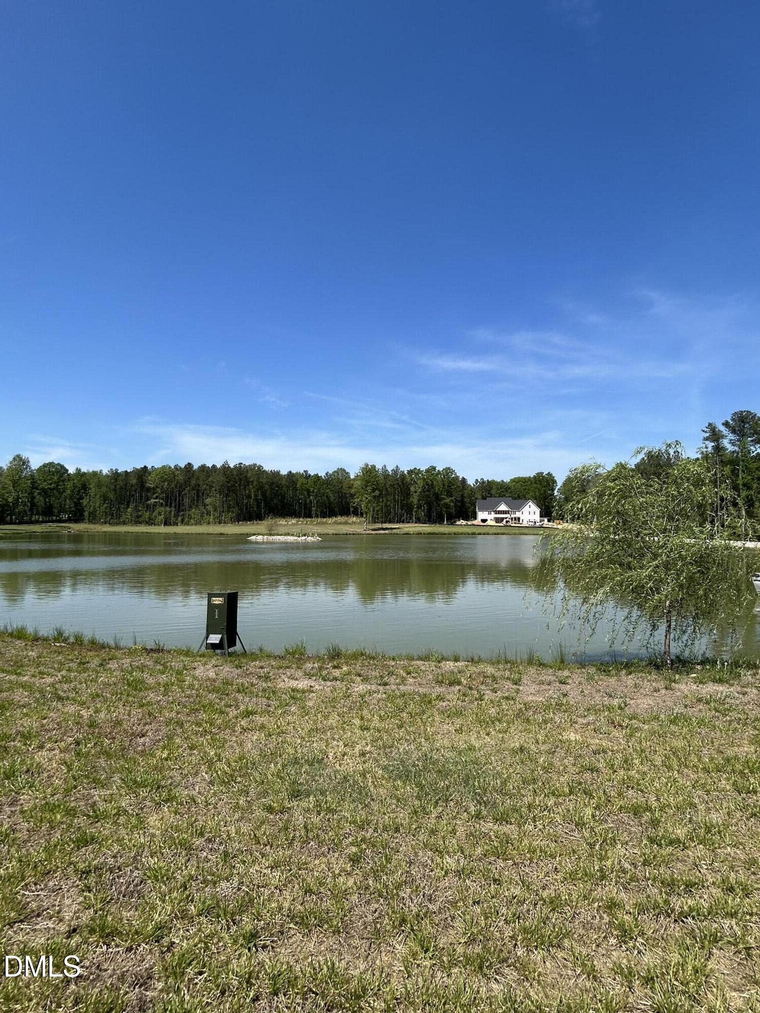 230 Bealy Farm Road Zebulon, NC 27597 - Photo 4 of 12 a view of a lake with a city