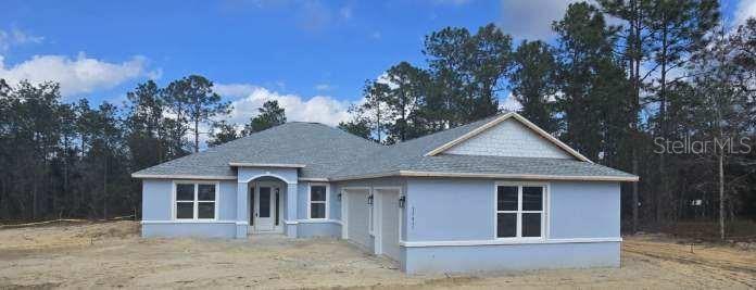 12411 Southwest 71st Lane Road Ocala, FL 34481 - Photo 3 of 50 a front view of a house with a garden