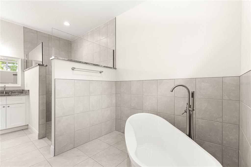 12411 Southwest 71st Lane Road Ocala, FL 34481 - Photo 33 of 50 a bathroom with a sink and shower