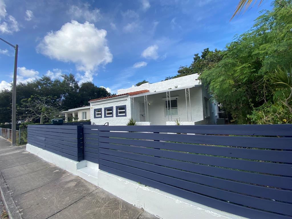a view of house with yard