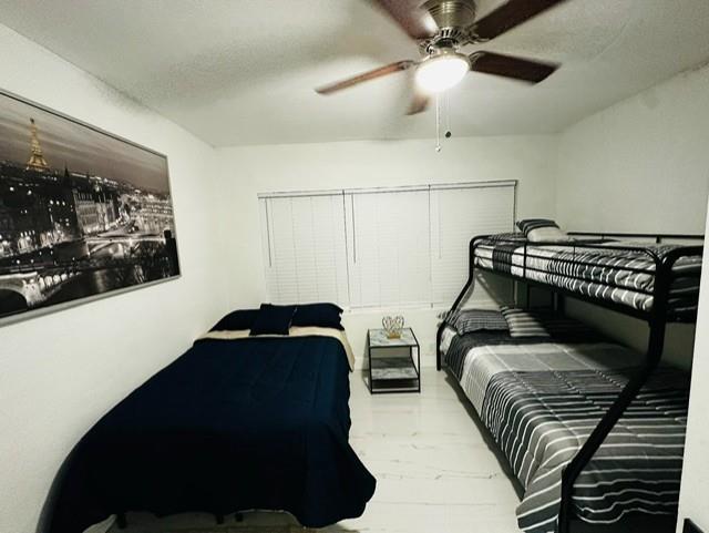 55 Northwest 47th Street Miami, FL 33127 - Photo 12 of 31 a bedroom with double bunk beds and a ceiling fan