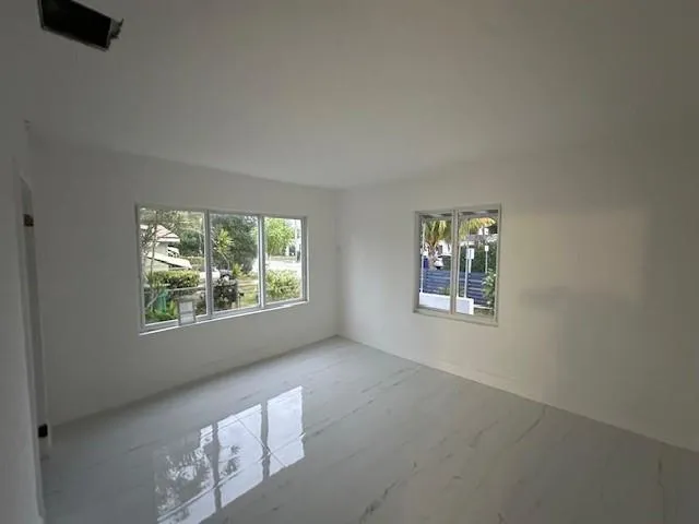 a view of an empty room with windows
