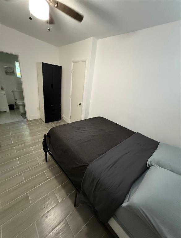 55 Northwest 47th Street Miami, FL 33127 - Photo 27 of 31 a bedroom with a bed and walk in closet