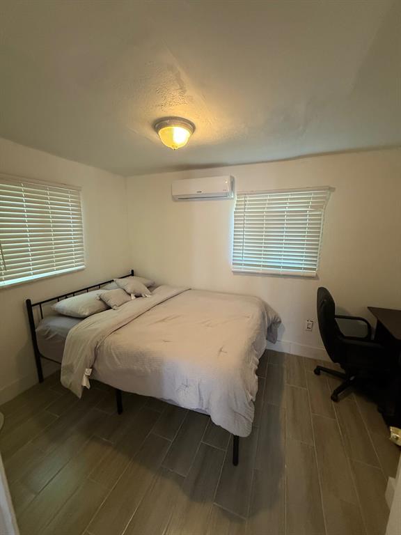 55 Northwest 47th Street Miami, FL 33127 - Photo 31 of 31 a bedroom with a bed and windows