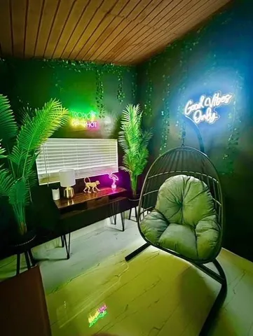 a backyard of a house with table and chairs with plants