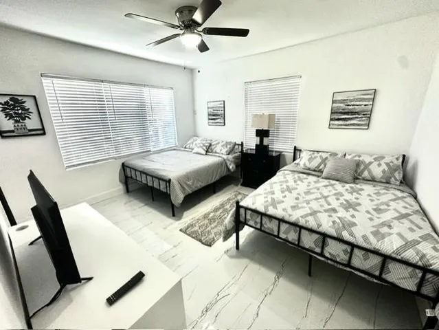 a bedroom with two beds and a large mirror