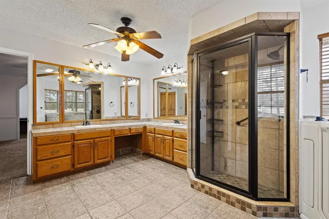 a large bathroom with a large tub shower and sink