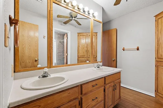a bathroom with a double vanity sink and a mirror